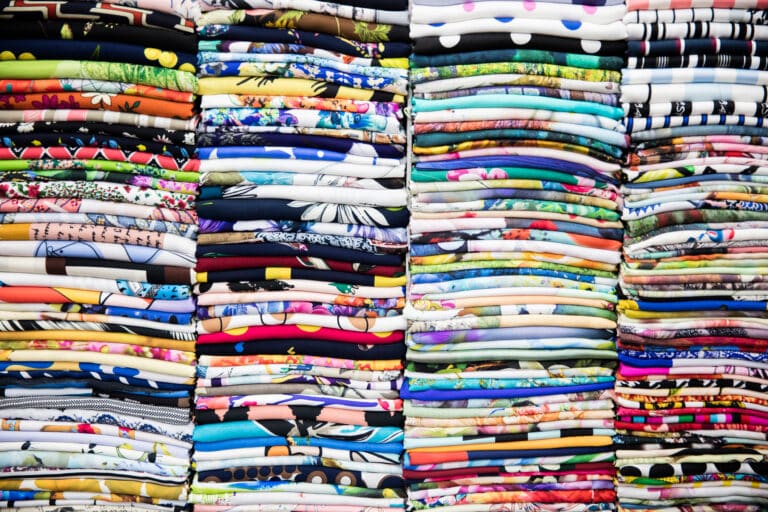 Print on demand Colourful T-Shirts piled up.